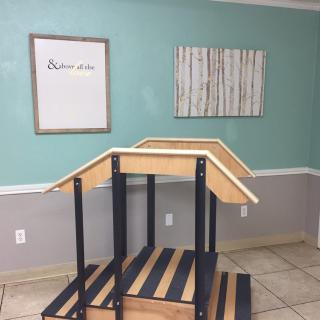 A physical therapy clinic featuring a set of stairs for rehabilitation exercises.