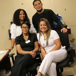 A group of colleagues posing for a picture in an office setting.