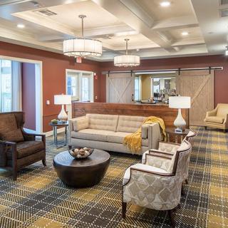 A cozy living room with elegant furniture and warm lighting.
