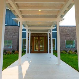Modern building entrance with a covered walkway.