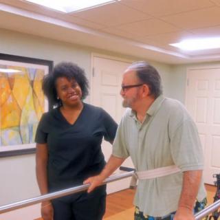 A therapist assists a patient during a rehabilitation session.