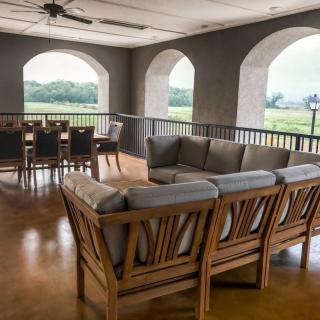 An elegant balcony with cozy wooden seating and a scenic view.