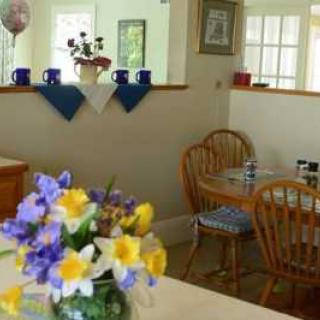 A cozy dining area with a vase of colorful flowers on the table.