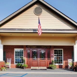 A building entrance with an American flag displayed above the door.