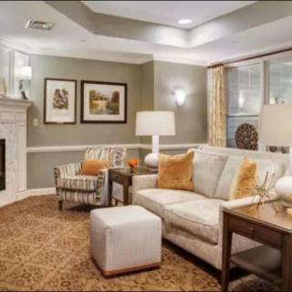 A cozy and well-decorated living room featuring a sofa, a chair, and a fireplace.