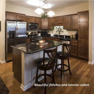 A modern kitchen with wood cabinets and stainless steel appliances.