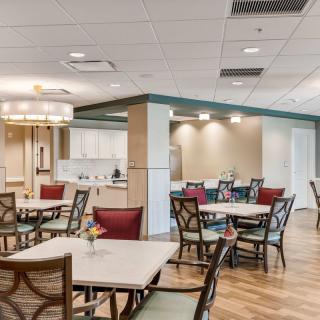 A modern dining area with neatly arranged tables and chairs.