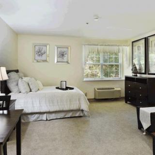 Spacious bedroom with ample natural light and modern decor.