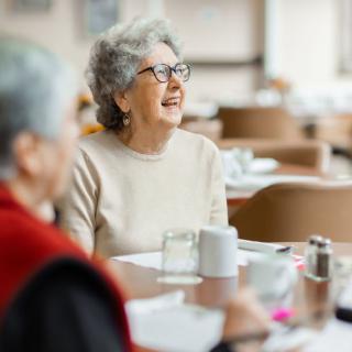 Elderly individuals enjoying social time at a restaurant.