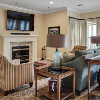 A cozy living room featuring a fireplace, sofa, and television.