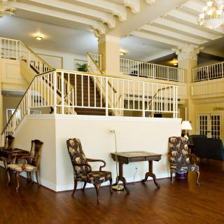 Spacious lobby with elegant furnishings and a prominent staircase.