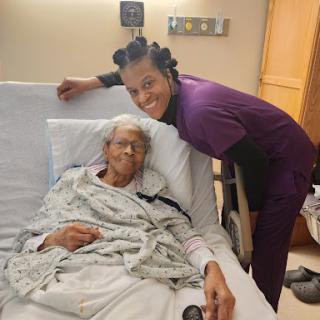 A touching moment between a nurse and an elderly patient in a hospital setting.
