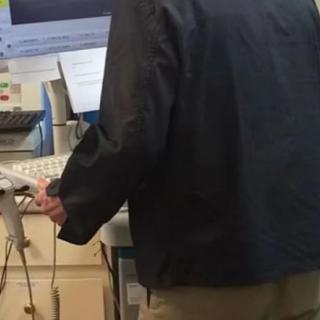 A person working at a computer station in an office environment.
