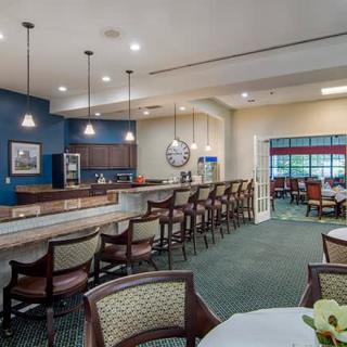 A spacious and modern bar and dining area with ample seating and stylish decor.