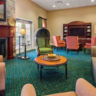 Cozy living room with a fireplace, comfortable seating, and a television.