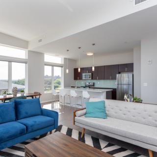 A modern open-plan living room with stylish furniture and abundant natural light.