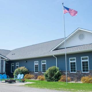 A building with an American flag flying on a sunny day.