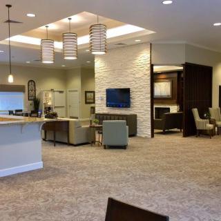 A modern lobby interior featuring comfortable seating and a television.