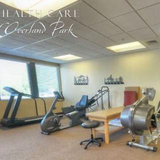 A well-equipped fitness space with various exercise machines for therapy and rehabilitation.