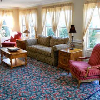 A cozy living room with classic furniture and ample natural light.