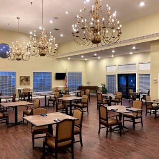 A spacious dining area with elegant chandeliers and a warm ambiance.