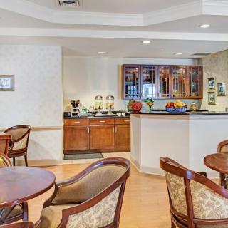 A cozy hotel dining area with a buffet setup and seating arrangement.