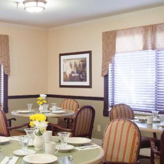 A cozy dining room with set tables, decorative elements, and ambient lighting.