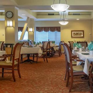 An elegant dining room with neatly arranged tables and chairs, ready for guests.