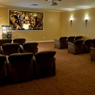 A cozy home theater setup with plush seating and a large screen.