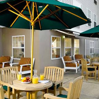 Outdoor patio area with tables, chairs, and umbrellas.