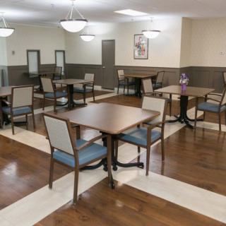 An empty dining area with neatly arranged tables and chairs.