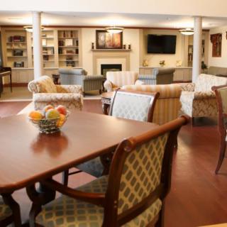 A cozy living room with comfortable seating, a fireplace, and a television.