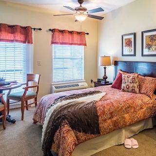 A cozy bedroom with warm decor and natural light.