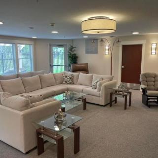 A modern living room with a large sectional sofa and stylish coffee tables.