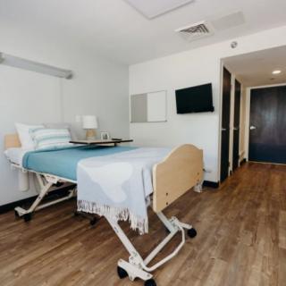 A modern and clean hospital room with a medical bed.