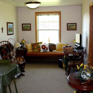 A cozy living room with a sofa, side tables, and decorative elements.