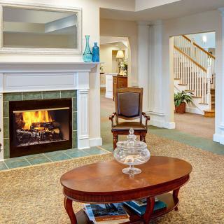 A cozy living room with a burning fireplace and elegant decor.