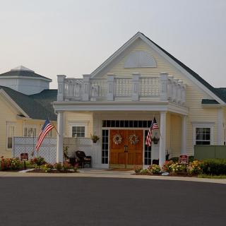 A suburban house with a decorated entrance and American flags.