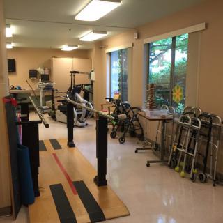 A physical therapy room equipped with various rehabilitation tools and exercise equipment.