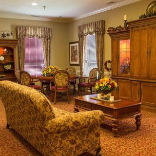 A cozy traditional living room with elegant furniture and warm lighting.
