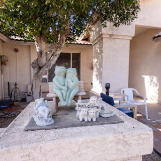 A serene outdoor setting featuring a couple sculpture and decorative elements.