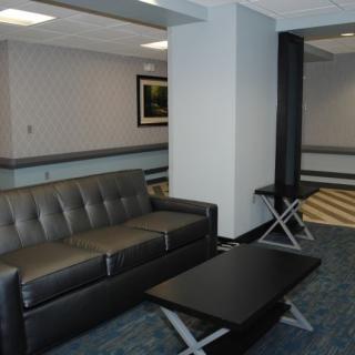 A modern lobby area with a leather sofa and coffee table.