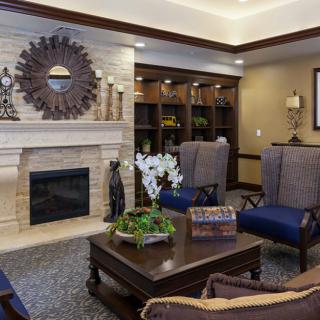 A modern living room featuring a cozy fireplace, stylish furniture, and elegant decor.