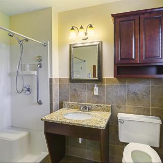 A clean and modern bathroom with a shower, sink, and toilet.