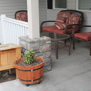 A cozy porch with comfortable chairs and planters.