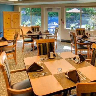 A cozy dining area with neatly arranged tables and chairs, ready for guests.