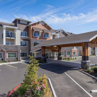 The exterior of a modern hotel with a welcoming entrance and well-maintained landscaping.