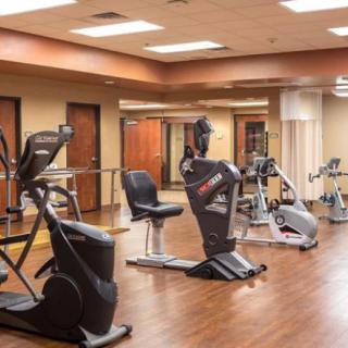 A well-equipped gym with various exercise machines and ample floor space.