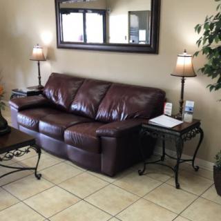 A cozy living room with a brown leather sofa and stylish decor.