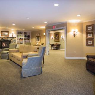 A cozy living room with a fireplace, sofas, and soft lighting.